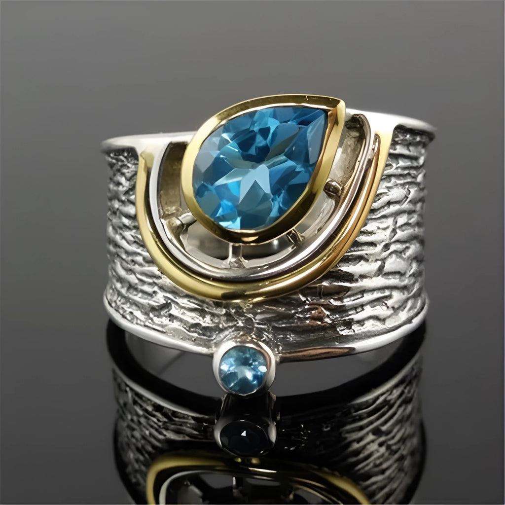 Close-up of a blue zircon and rhinestone drop-shaped ring in a Chinese style design.
