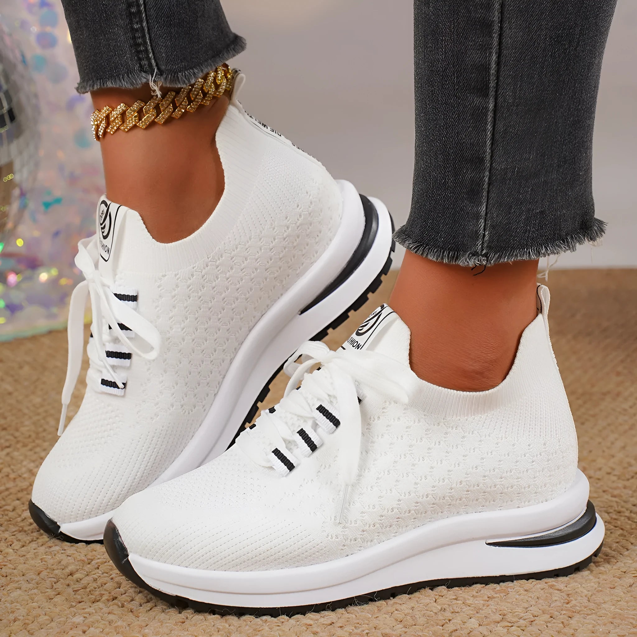 Women's black lace-up mesh sneakers with a flat rubber sole and round toe on a white background.