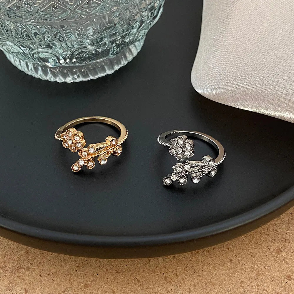 Women's diamond flower leaves open ring in gold and white colour options showing floral design