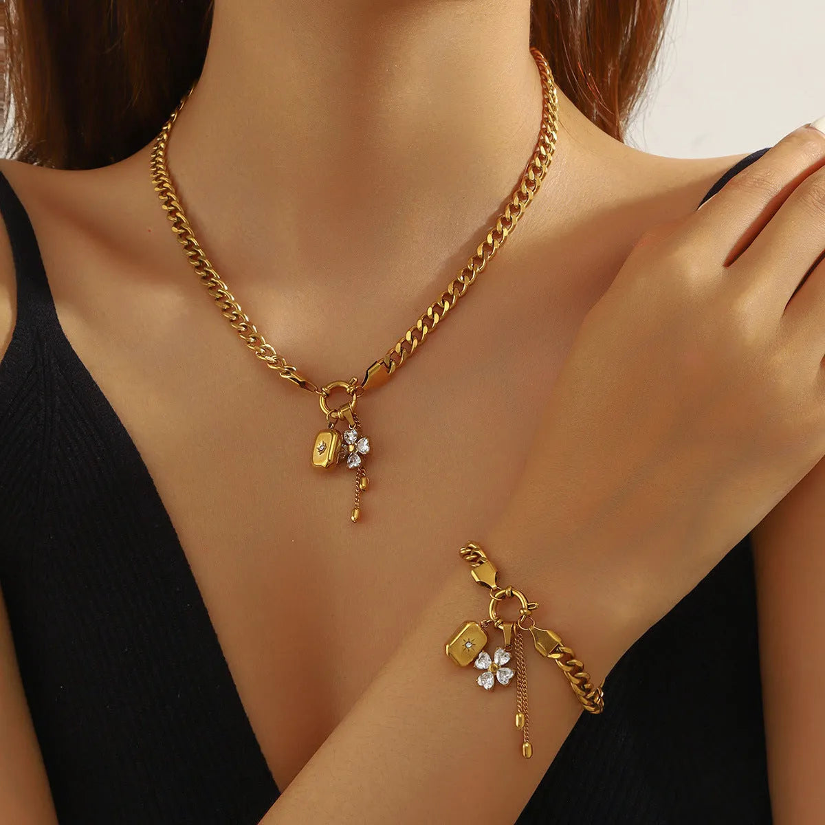 Tassel stainless steel bracelet and necklace set with flower and butterfly motifs for women