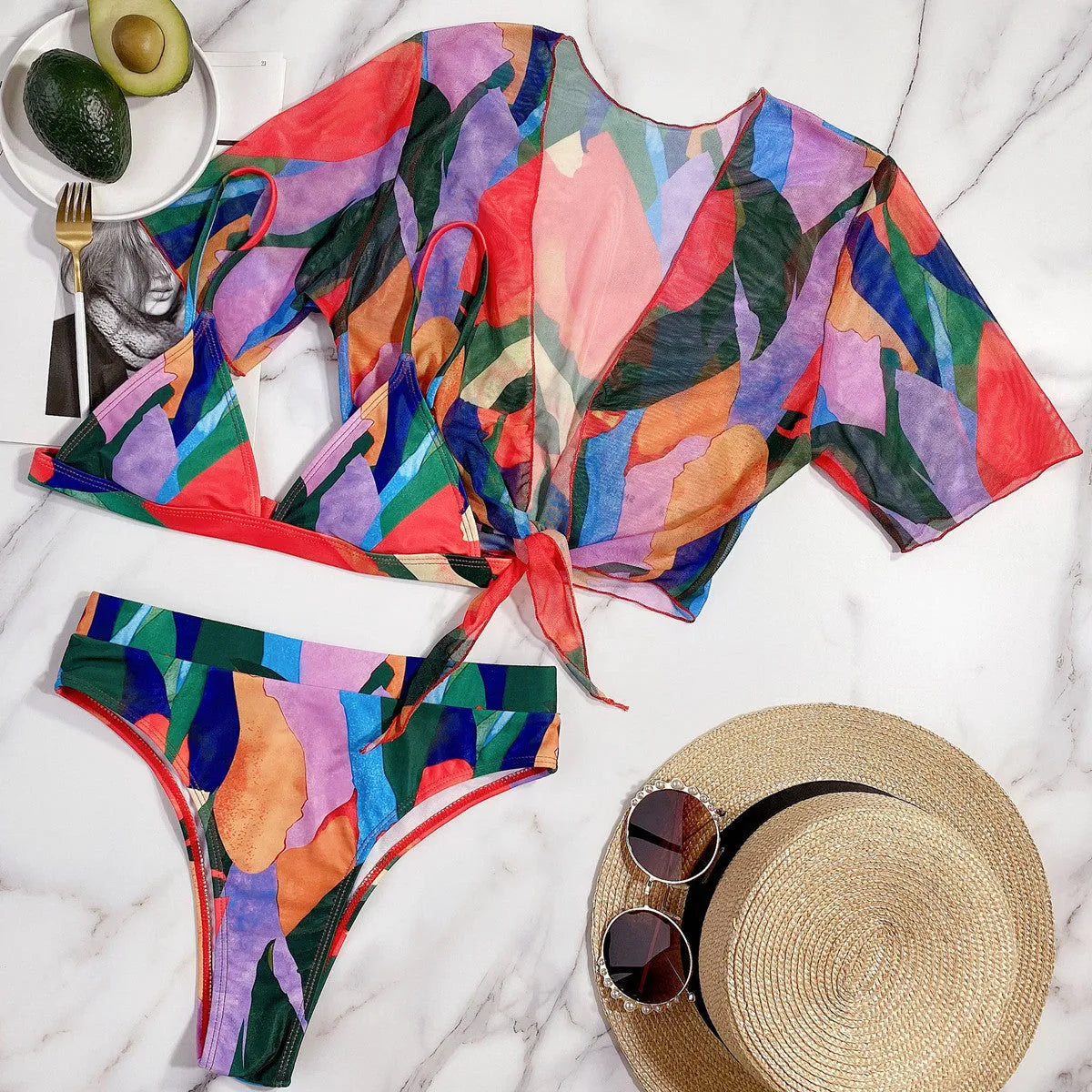 Red women's nylon split swimsuit on a hanger, showing printed design and bikini style.