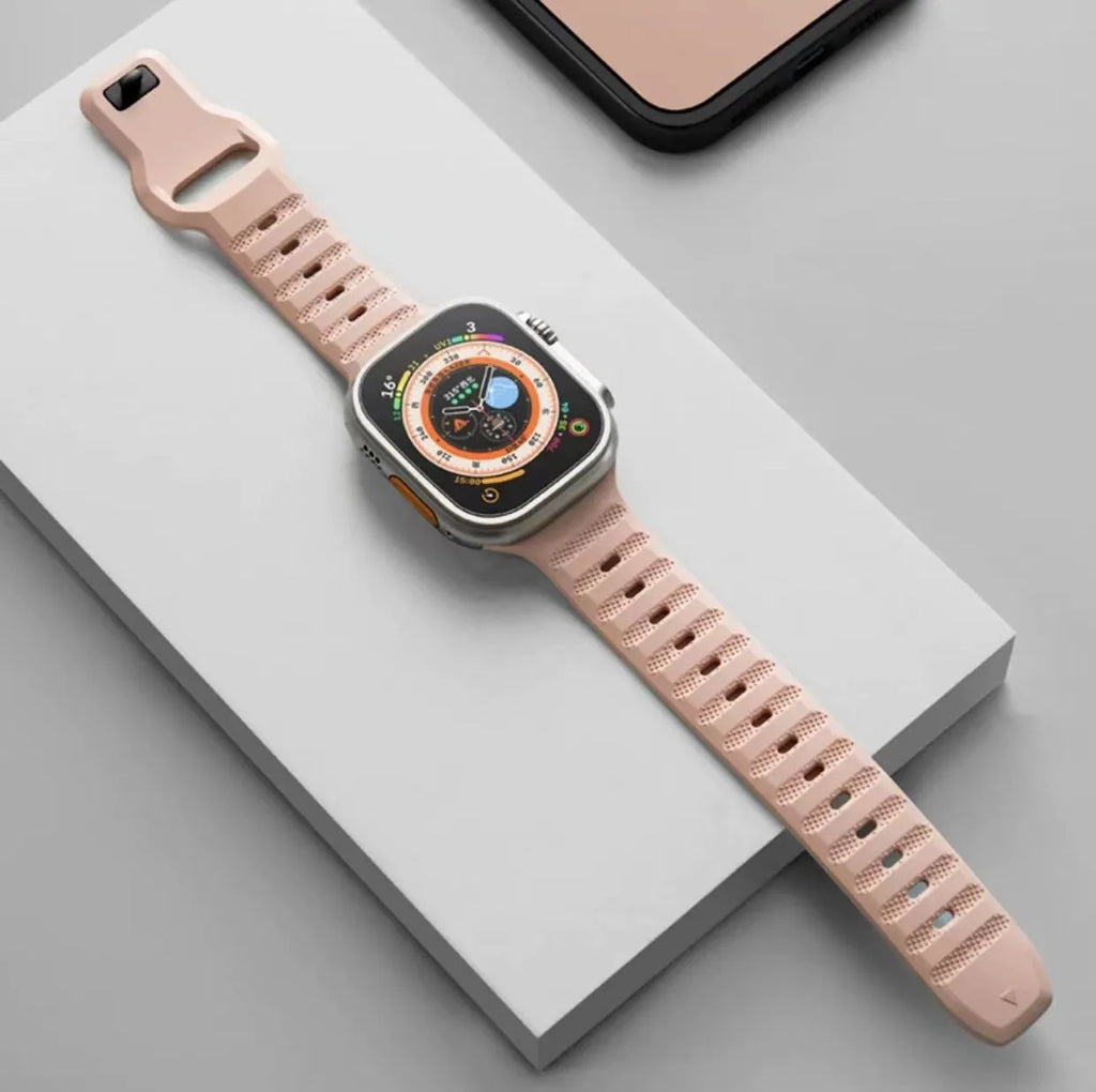 Fluoro rubber Apple Watch replacement strap with T buckle in one of six colours on a wrist.