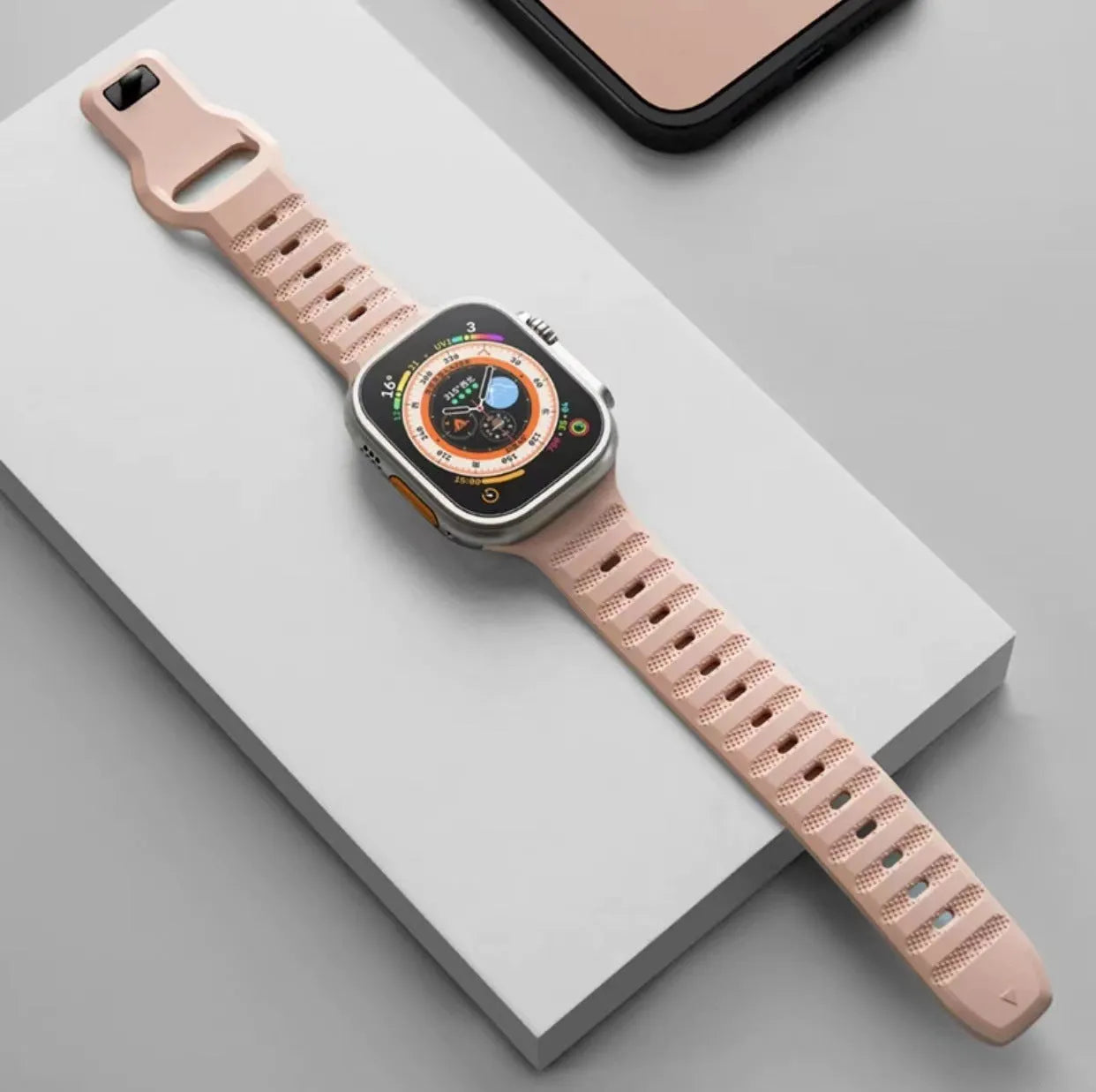 Fluoro rubber Apple Watch replacement strap with T buckle in one of six colours on a wrist.