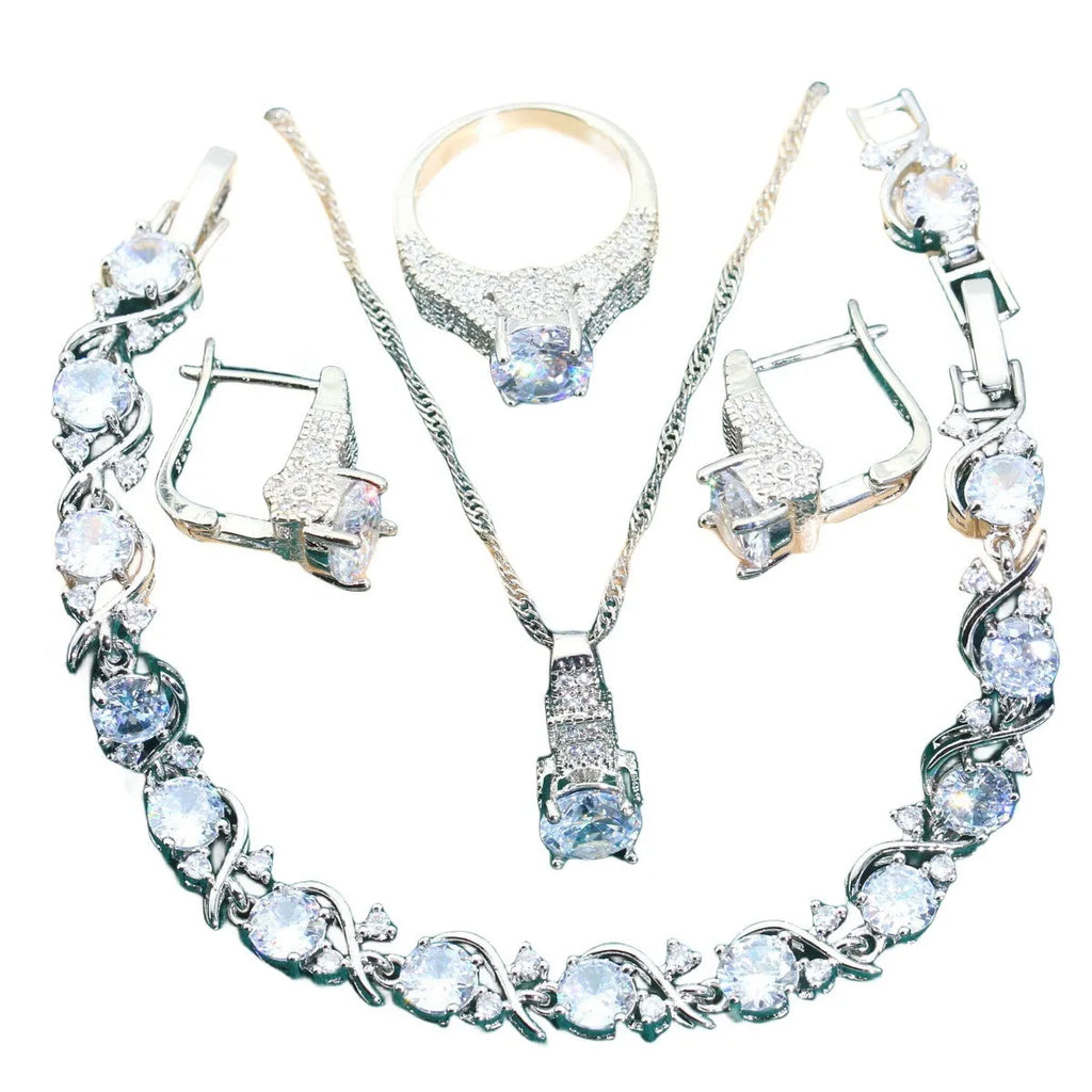 Four-piece bridal jewellery set showing zircon necklace, bracelet, earrings, and ring in coordinating design