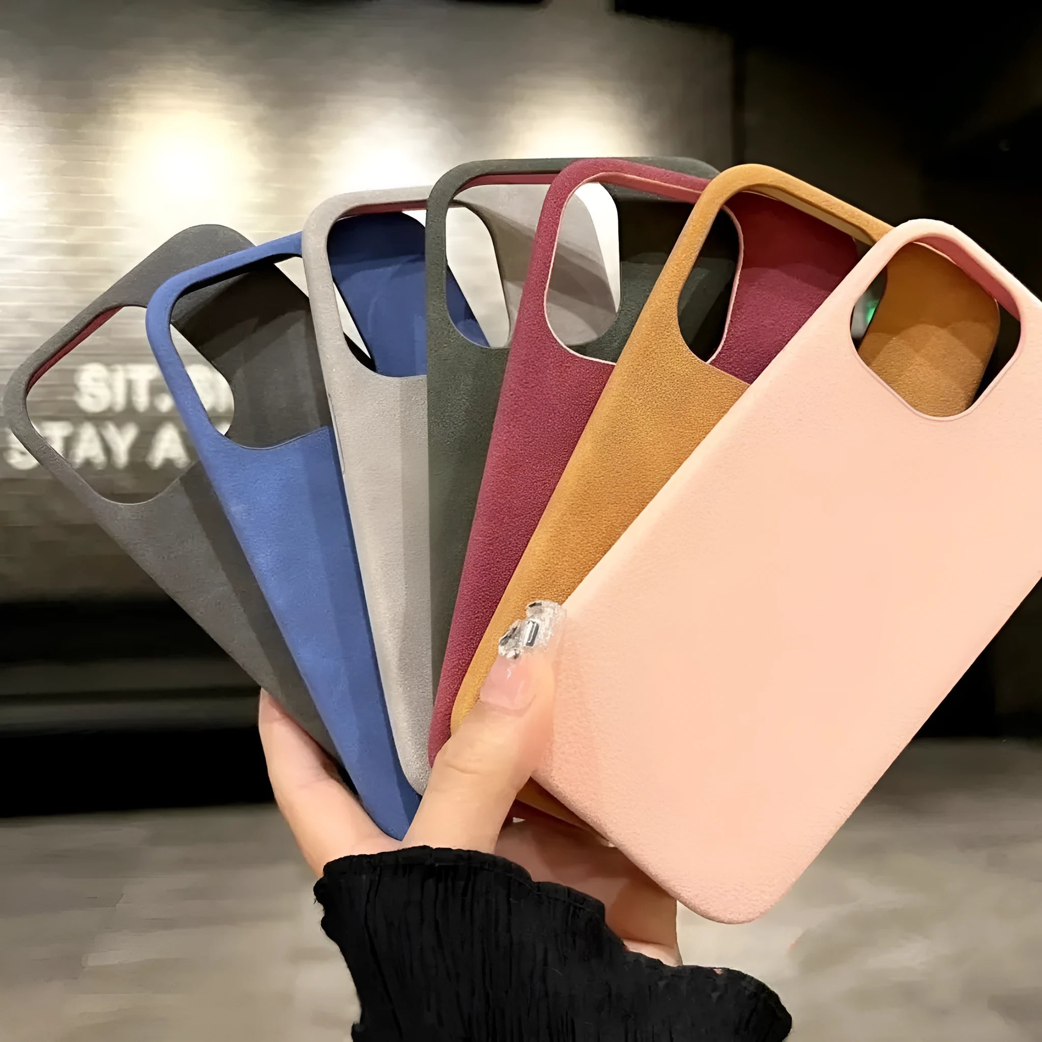 Solid colour imitation suede shockproof iPhone case with frosted finish on a table.