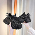 Women's mesh breathable platform sneakers in black, low-top lace-up design with mid heel