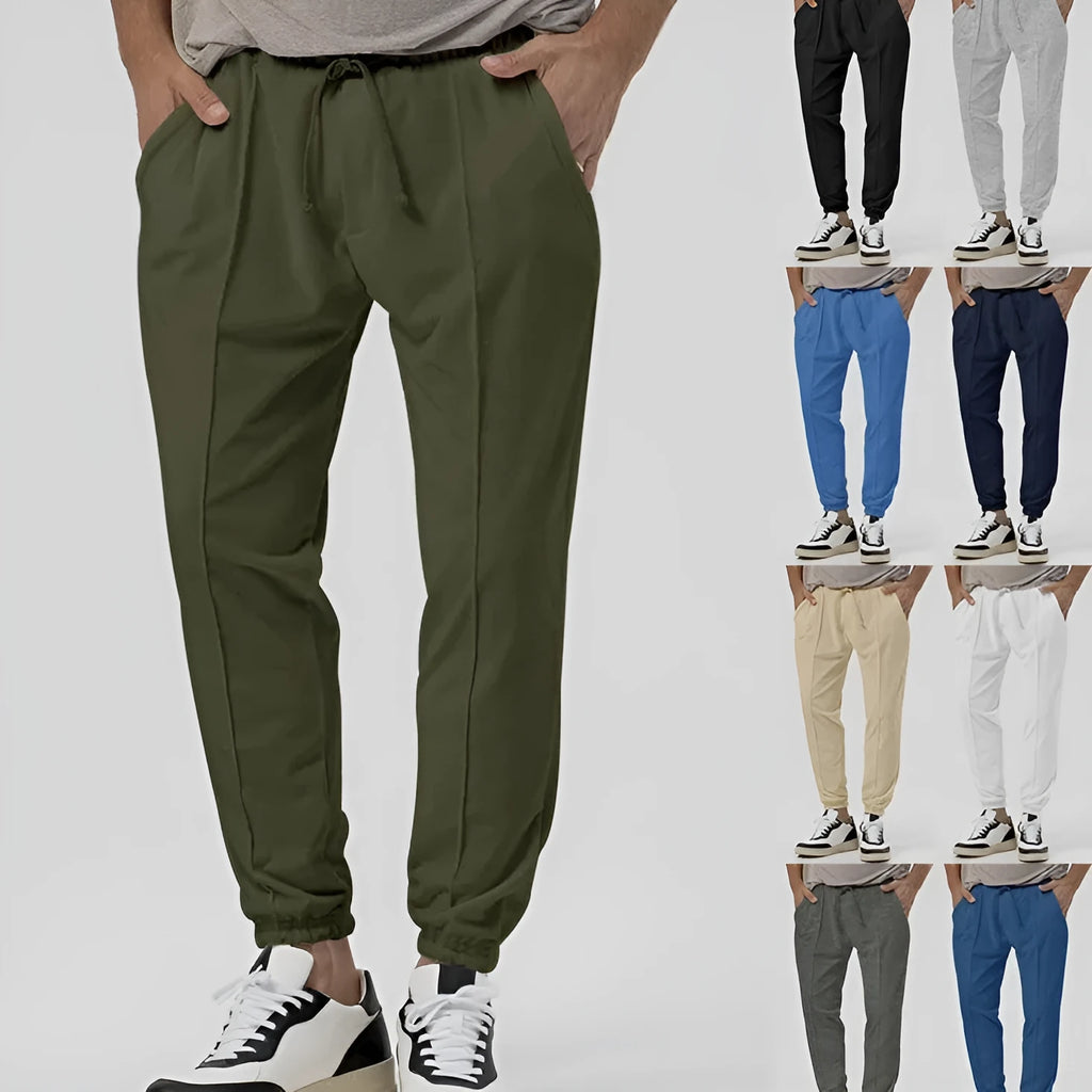 Men's grey elastic track sweatpants with tapered straight-leg design and elastic waistband