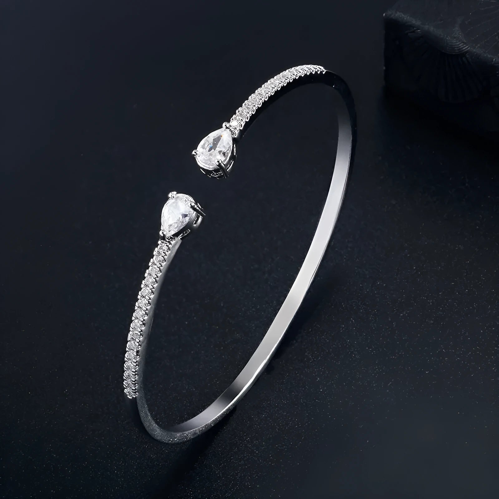 Copper bracelet with inlaid zircon decoration in blue colour on wrist