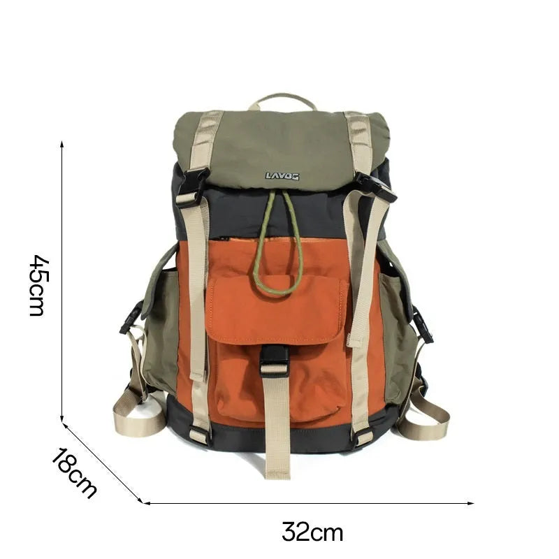 Orange and green contrast colour large nylon backpack with multiple compartments on a plain background.