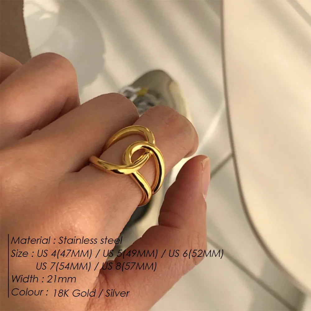 Women's stainless steel adjustable ring with knotted detail in gold or steel colour on a grey background.