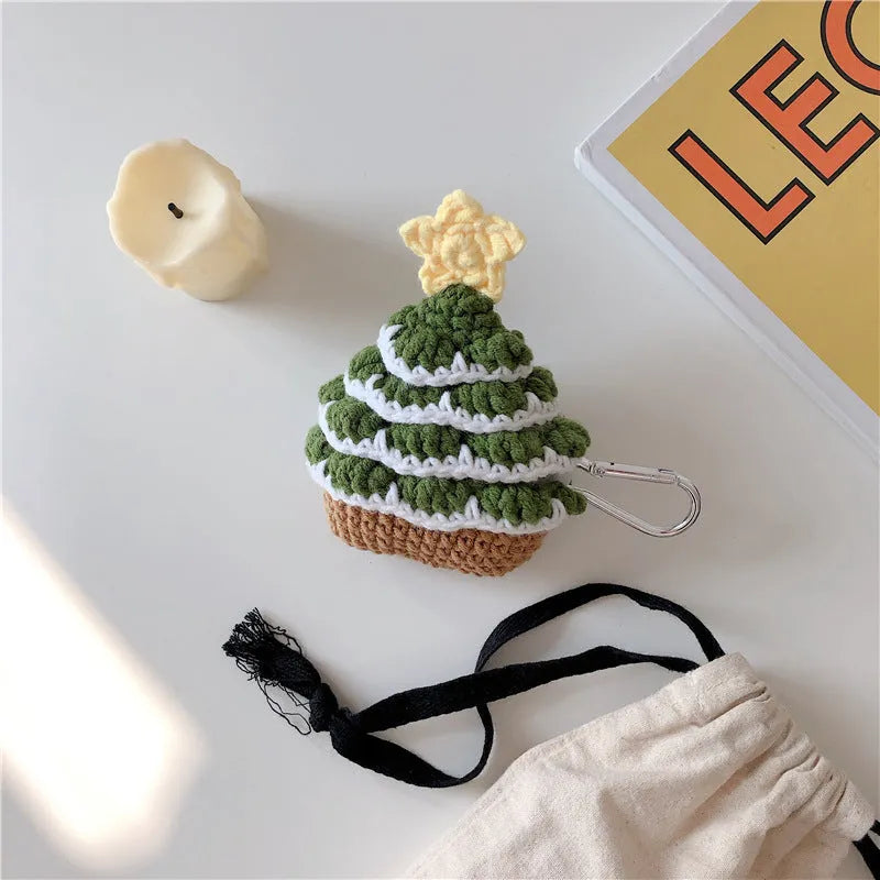 Green knitted Christmas tree flip-style headset case for AirPods with silver hook on white background