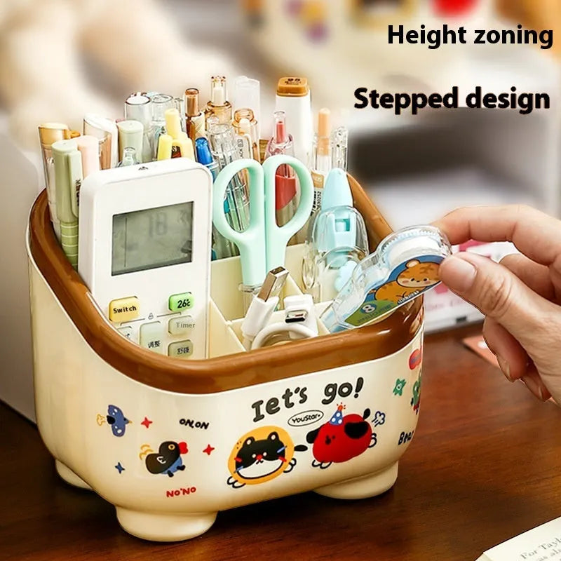 Cartoon-style plastic desktop organiser with various red and brown storage boxes and a pen holder.