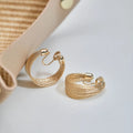 Geometric copper earrings with electroplated silver or gold finish, shown as stud and clip-on styles
