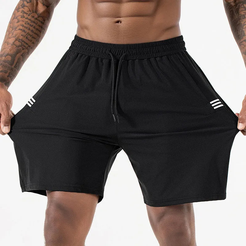 Man wearing black ice silk sport shorts with a high waist and cropped length.