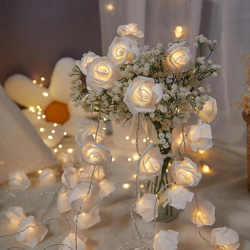 LED rose-shaped fairy light string with PV foam lamps on a 1.5m battery-powered cord for indoor holiday decoration.