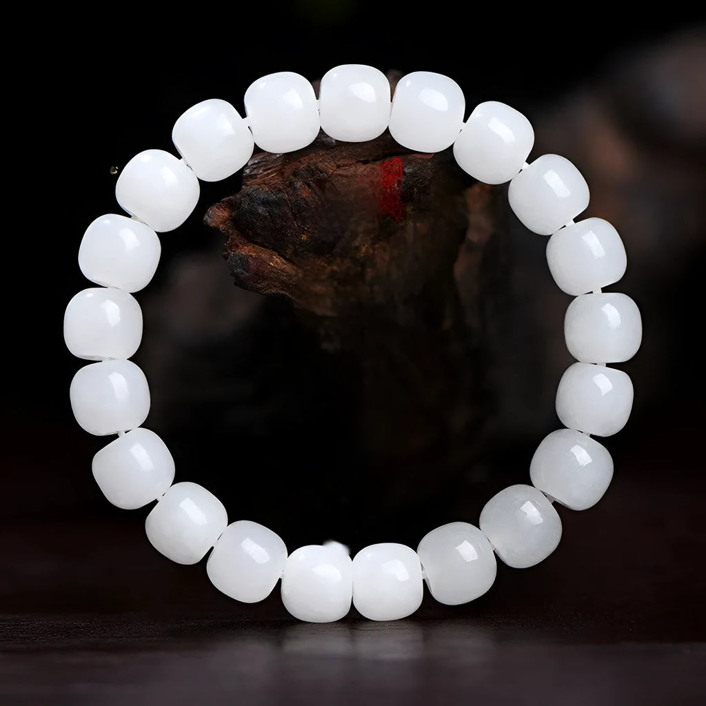 White Hetian jade barrel bead bracelet on wrist, showing unisex design and elasticated band.