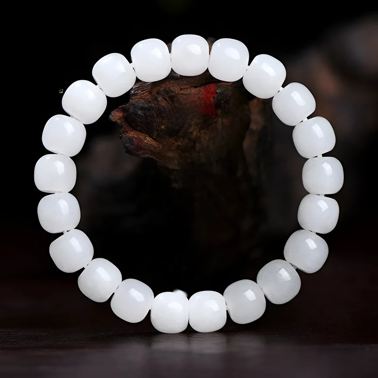 White Hetian jade barrel bead bracelet on wrist, showing unisex design and elasticated band.
