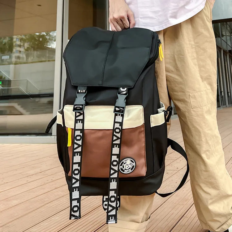 Oxford cloth backpack in black, green, or red with shoulder straps and handle