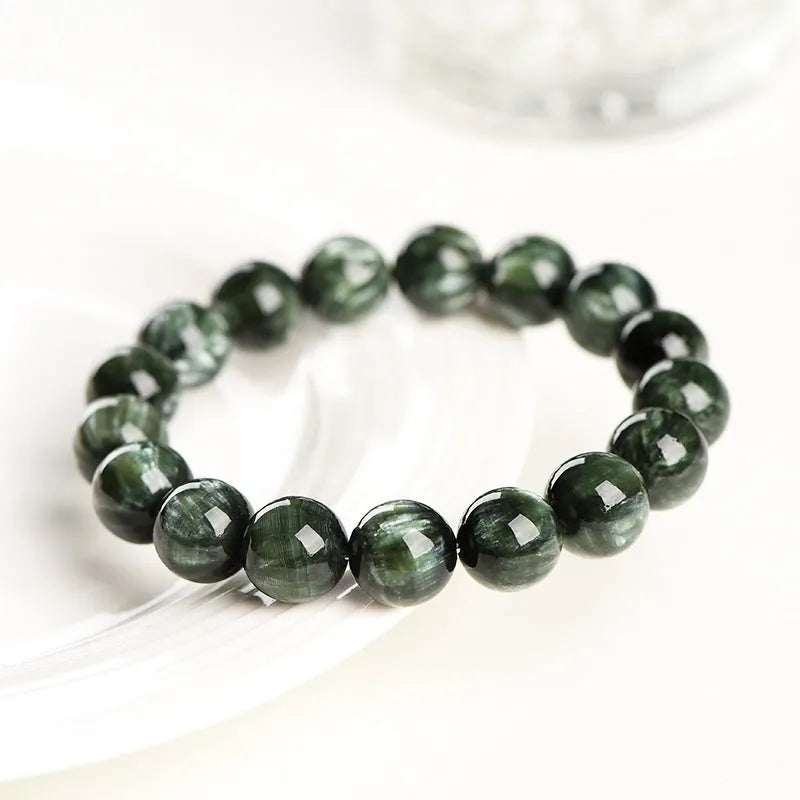 Green Dragon Crystal round bead bracelet with Ruyi design elements on a wrist.