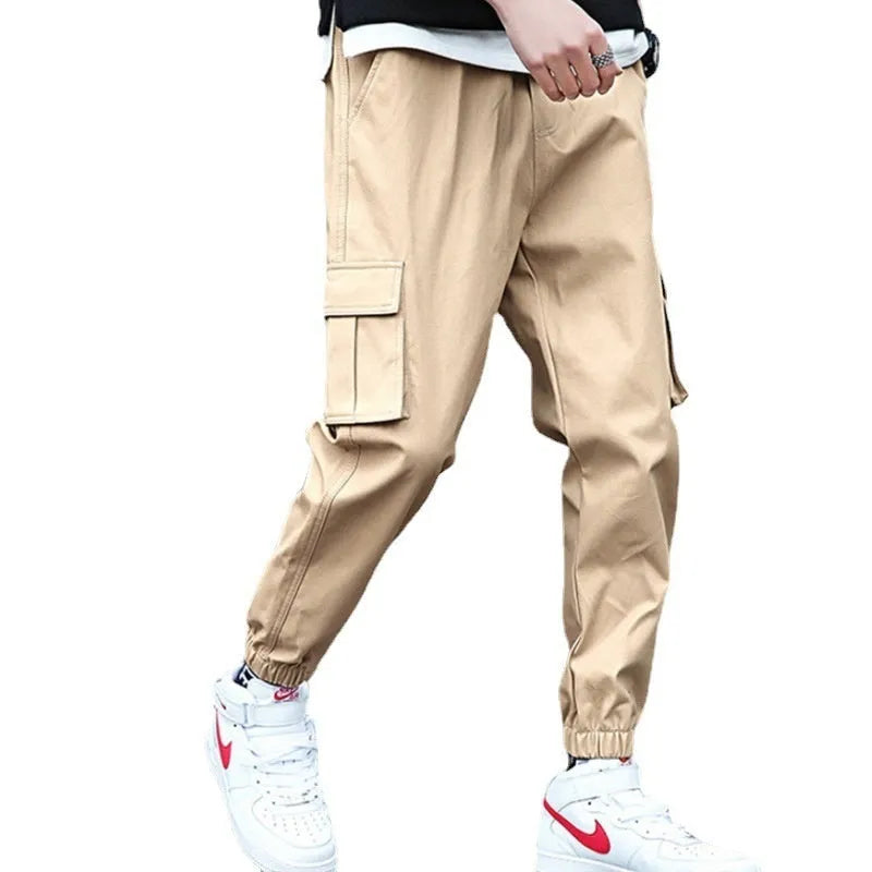 Khaki multi-pocket harem trousers with tapered mid-waist and elastic waistband, polyester fabric