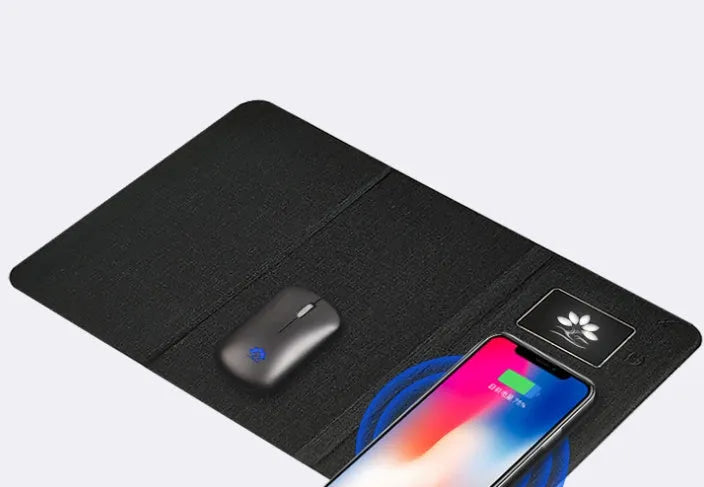 Folding cloth wireless charging mouse pad and small black wireless mouse shown with a portable handbag.