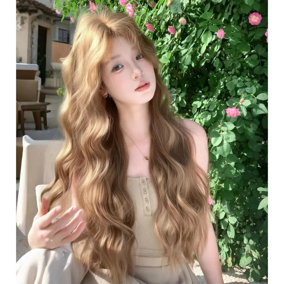 A brown curly synthetic wig with a linen hue and medium length on a wig stand.