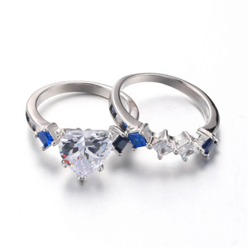 Silver-tone alloy heart-shaped geometric ring set on hand showing silver finish and multiple rings