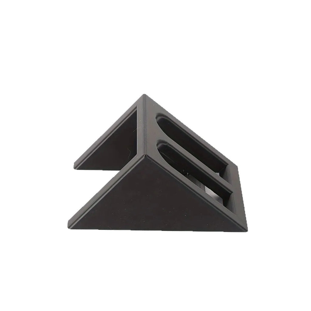 Black punk-style plastic pistol display stand on a flat surface.
