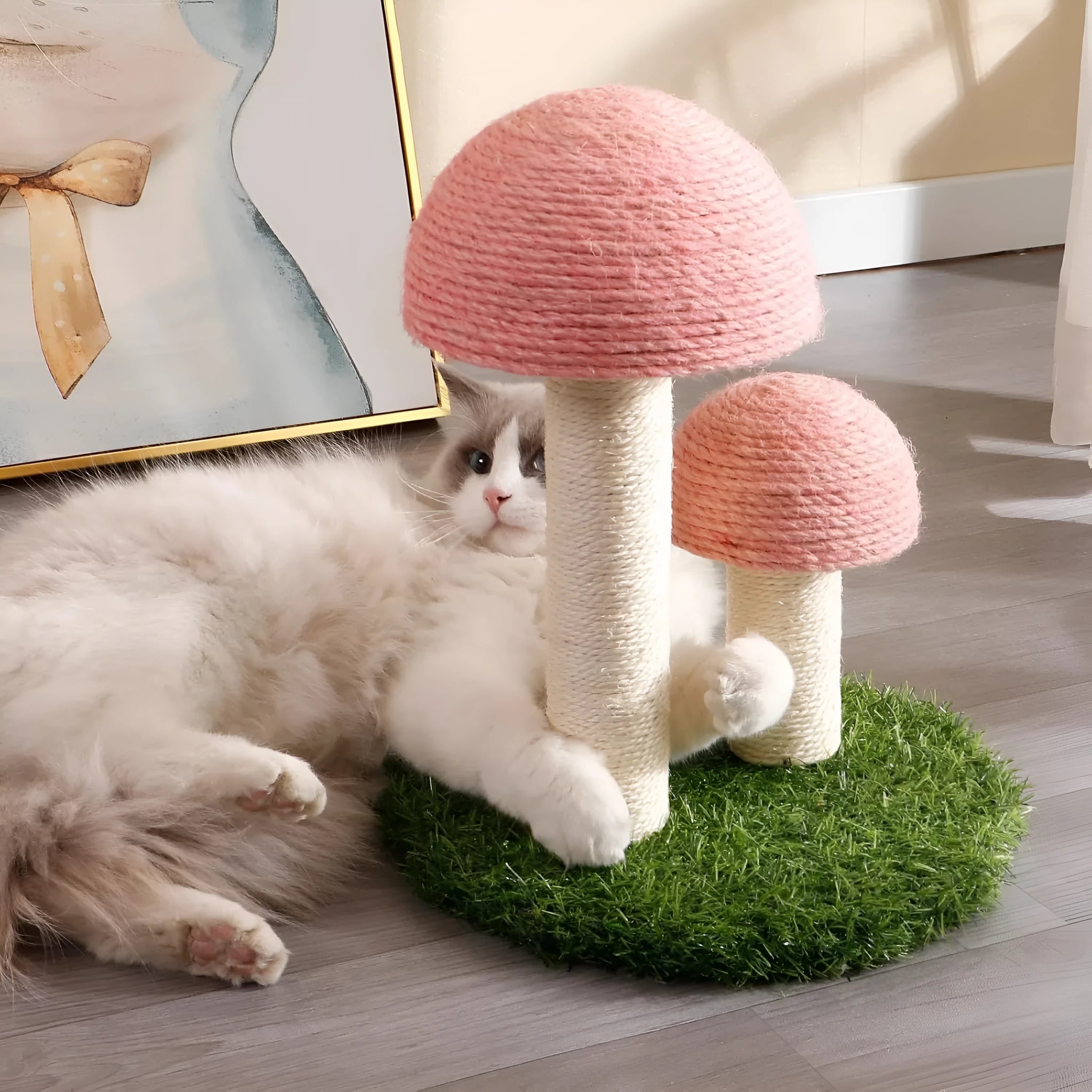 Pink mushroom-shaped cat scratching post with natural sisal fibre covering, for kittens and small cats.