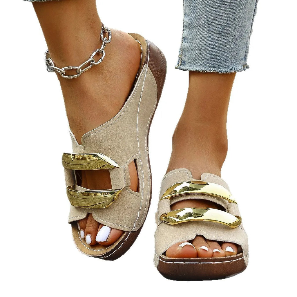 Roman style platform flip-flops in black with metal accents and rubber sole.