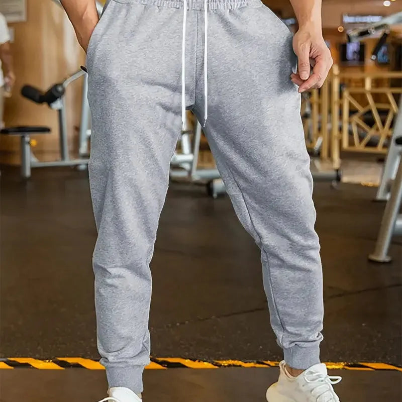 Men's grey linen-style leisure trousers with elastic drawstring waist and loose fit