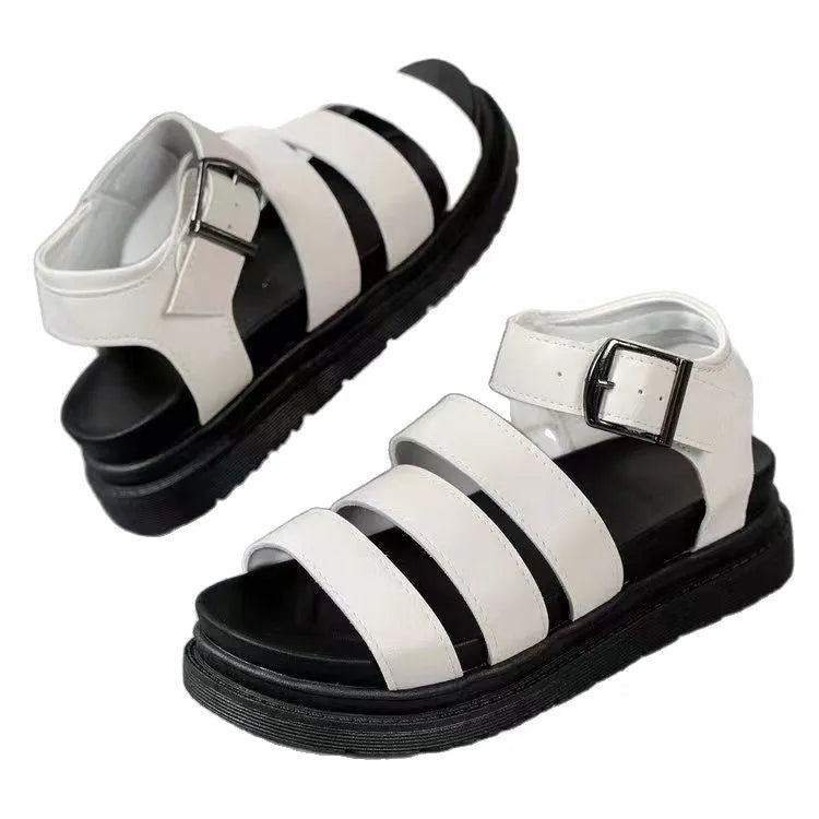 A pair of black casual sandals with a buckle strap and thick rubber sole, showing the fish mouth toe design.