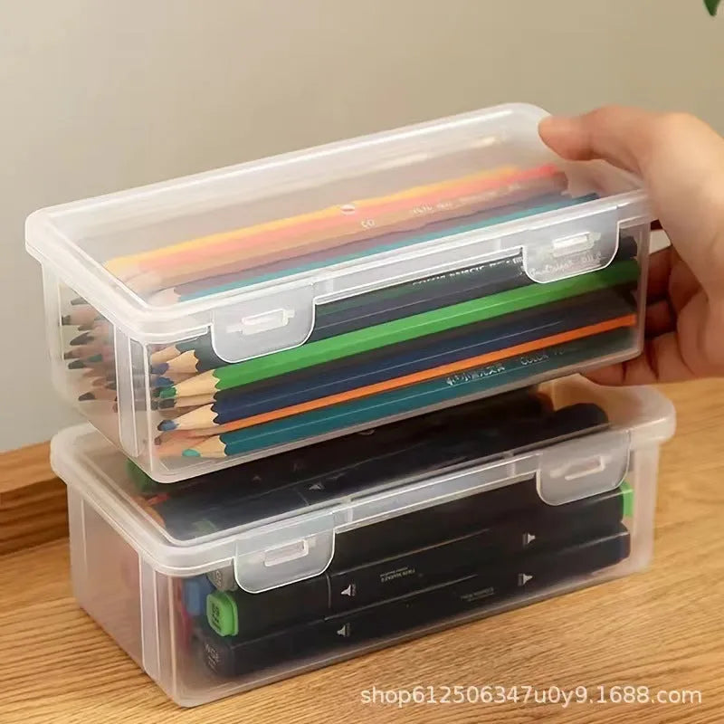 Large transparent plastic stationery storage box filled with coloured pencils and pens