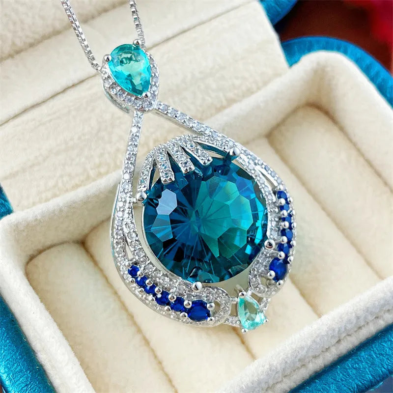 Blue geometric crystal pendant necklace on a silver water wave chain for women