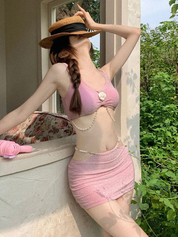 Women's pink and black three-piece polyester bikini set for swimming.