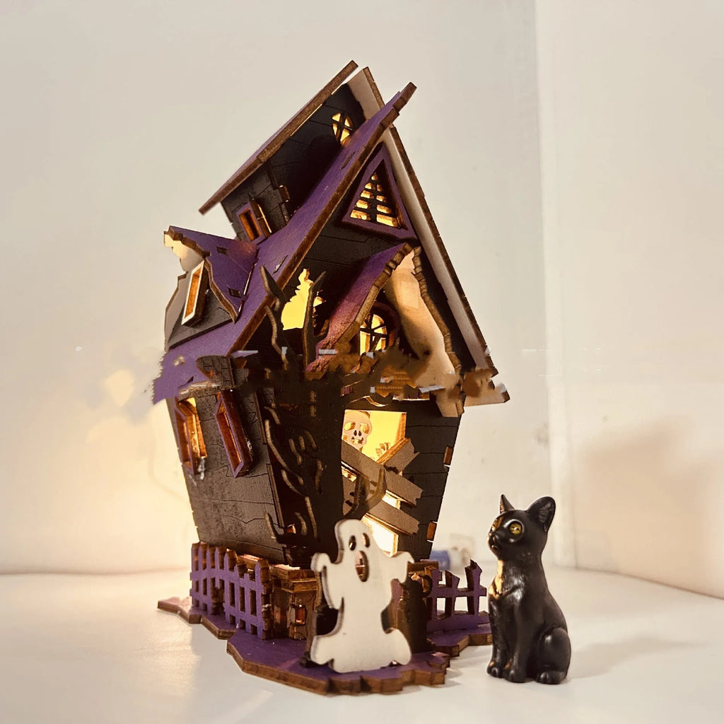 Wooden glowing haunted house Halloween table decoration with candlestick holder, 14cm wide.