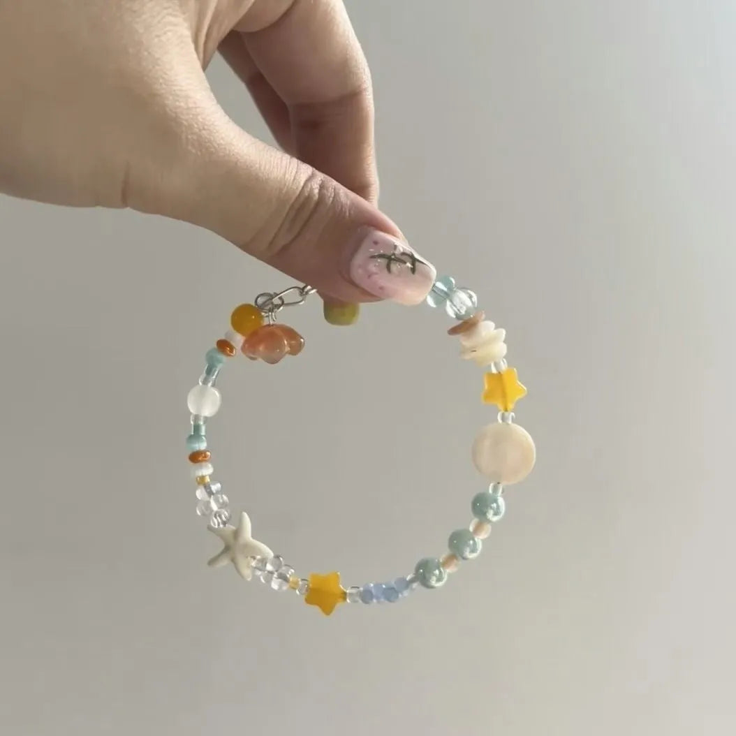 Orange sea coloured alloy bracelet with diamond shape and round element design for women