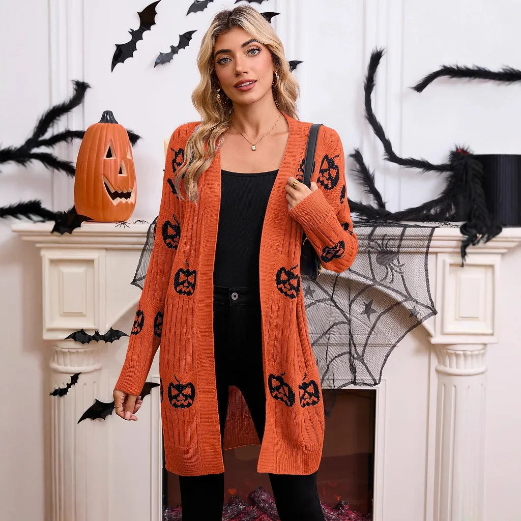 Women's black Halloween cardigan with orange Jacquard knitted pumpkin head pattern, shown on a hanger.