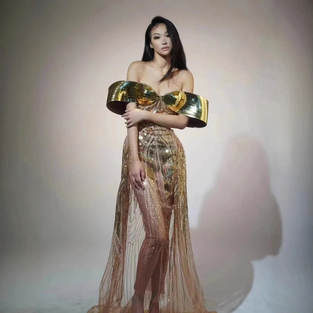 Gold strapless sequin dress with sleeveless tube top and long one-step skirt.