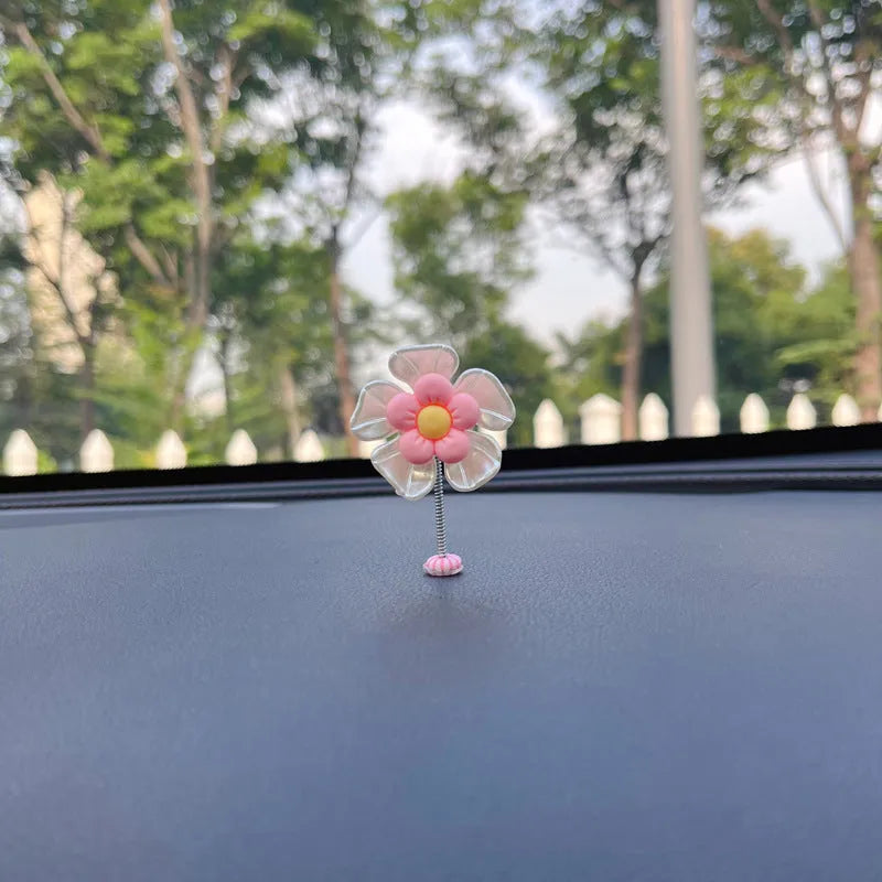 Coloured plastic car decoration swing ornament measuring approximately 5cm by 3.5cm