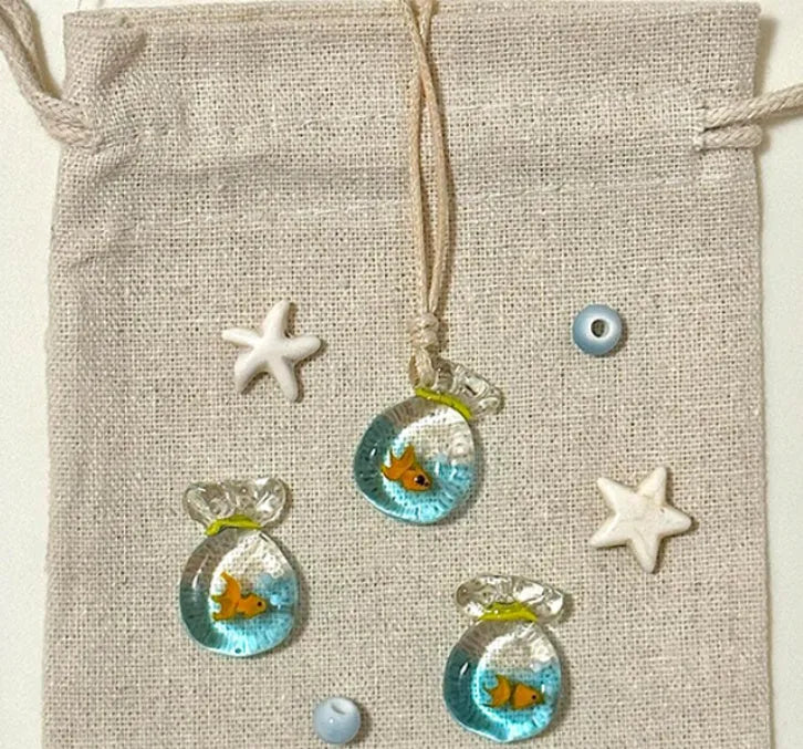 Women's pendant necklace with coloured glaze charm on a cotton and linen clavicle chain in Small Fish Lucky Bag colour.