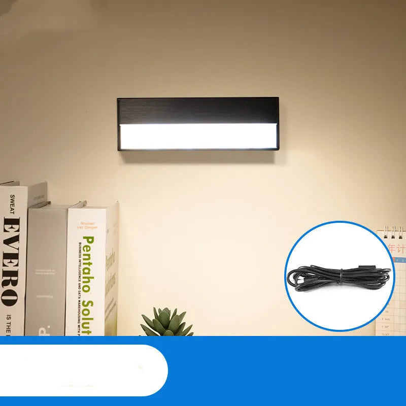 Compact white magnetic LED desk lamp with touch dimming on a wooden desk.
