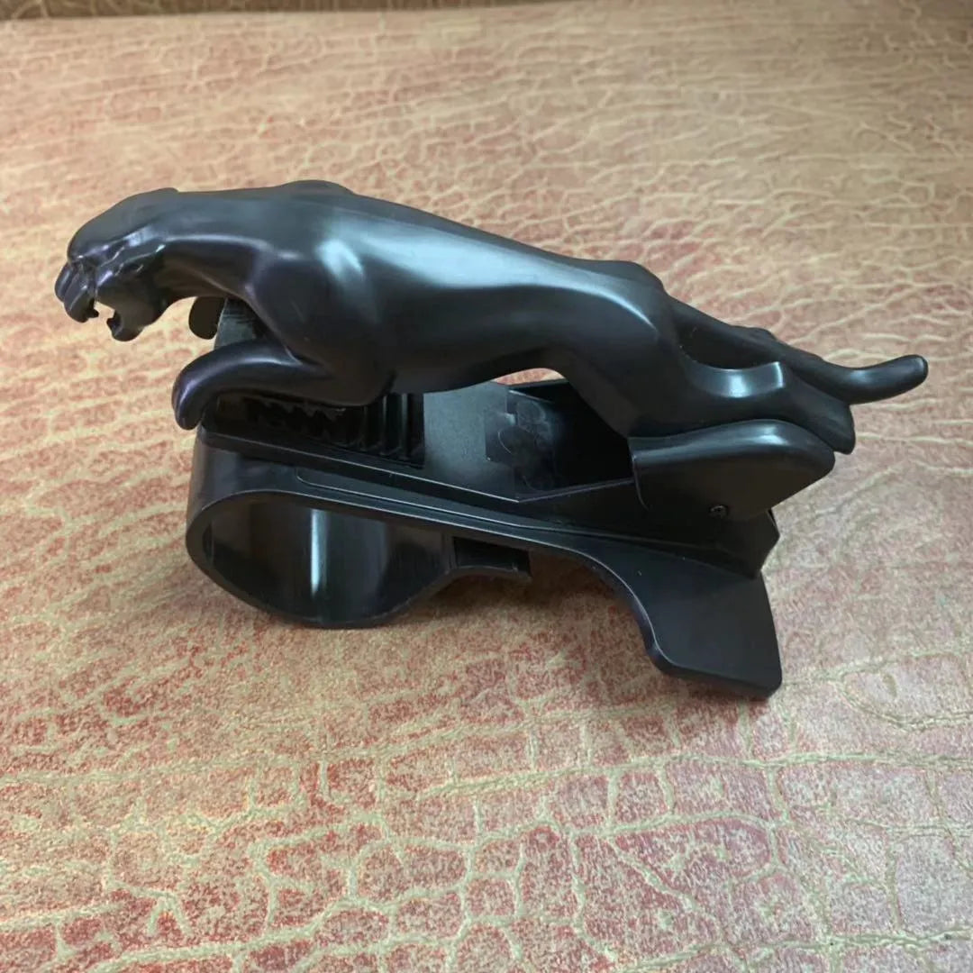 Black ABS car mobile phone holder with a 360-degree rotatable bracket mounted on a car dashboard