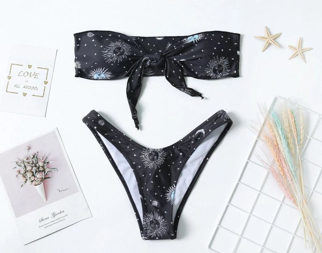 Black one-piece swimsuit with bikini print pattern and split tube top design.