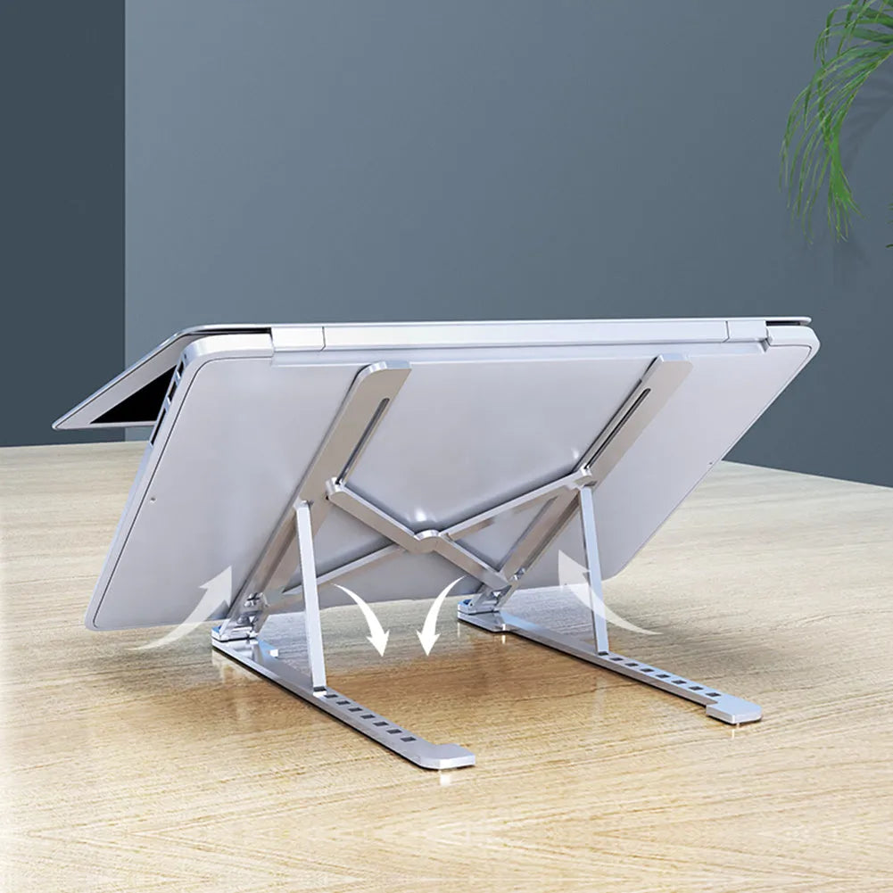 Deep grey foldable aluminium laptop stand holding a silver laptop at an angle.