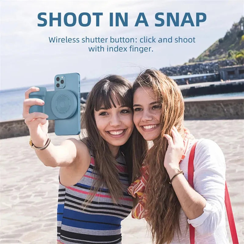 Black magnetic camera handle phone bracket with rotatable grip on wooden table