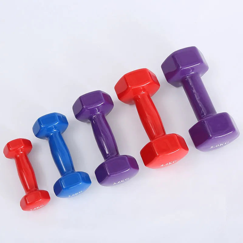 Bright plastic coated fitness dumbbells in various weights for home gym yoga and aerobics