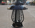 White and black solar-powered mosquito lamp with solar panel on top for outdoor garden use.