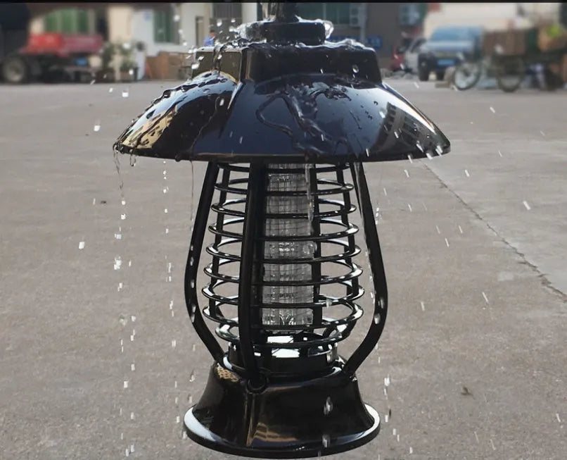 White and black solar-powered mosquito lamp with solar panel on top for outdoor garden use.