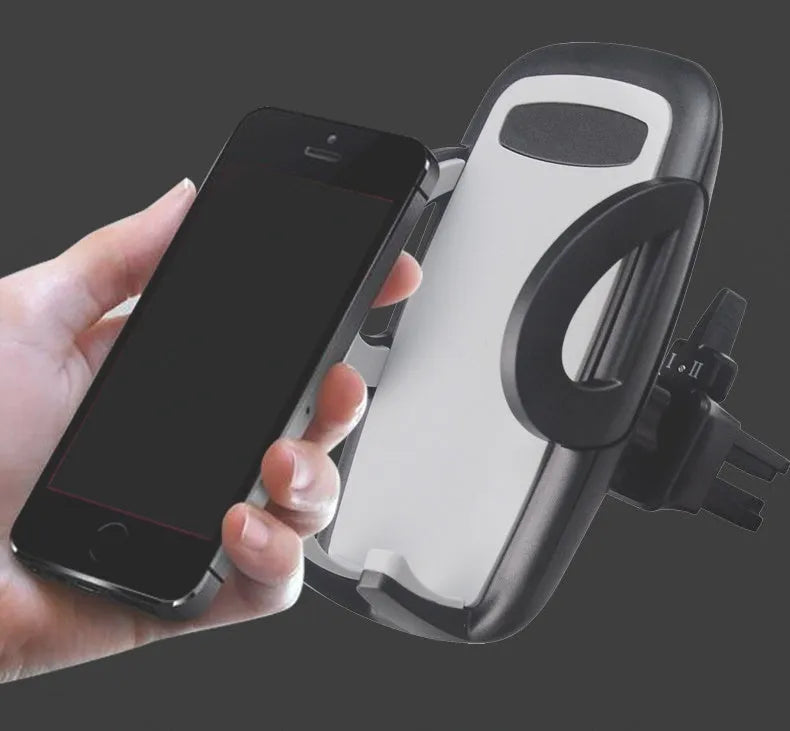 Black plastic mobile phone holder attached to car air conditioning vent